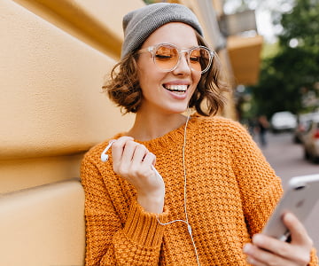Woman with phone and headphones